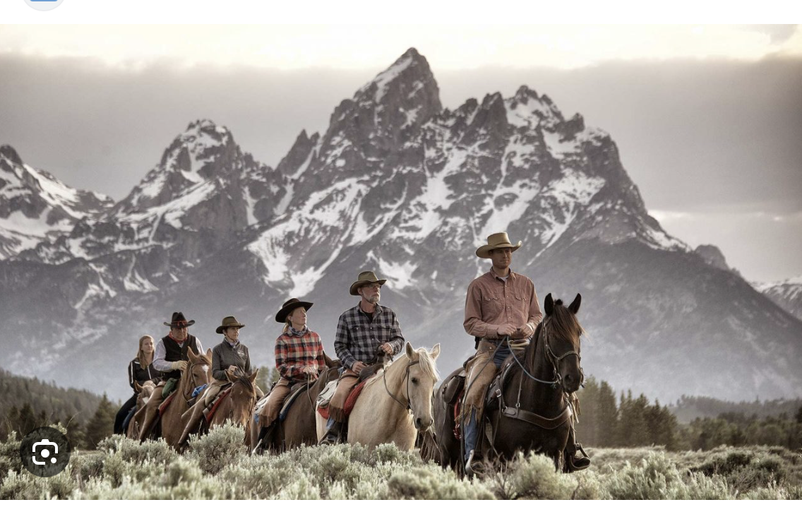 Riders on horseback beneath the Tetons